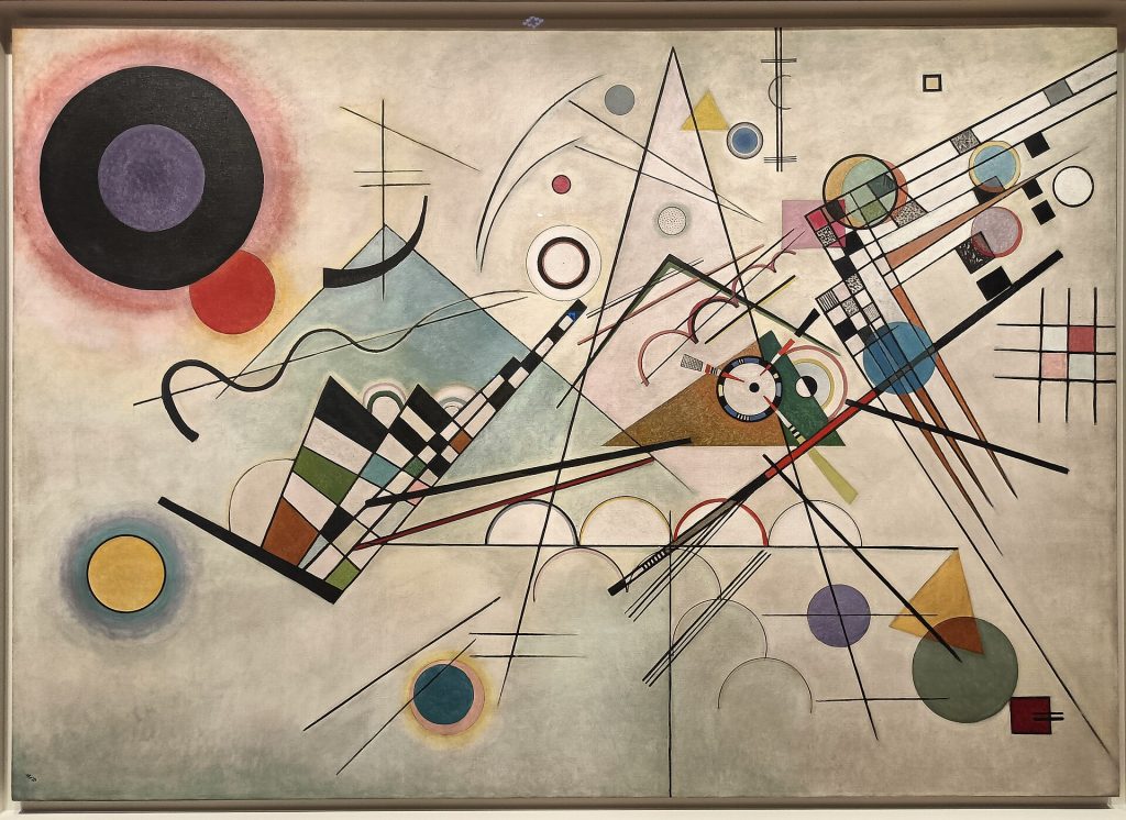 Abstract composition of geometric circles, triangles and lines in blue, yellow, red and black