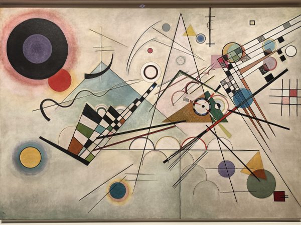 Abstract composition of geometric circles, triangles and lines in blue, yellow, red and black